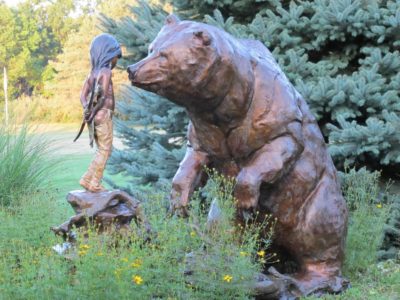 large sculpture bear and a girl