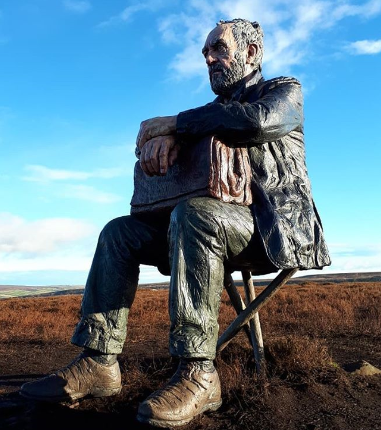 bronze sitting man sculpture