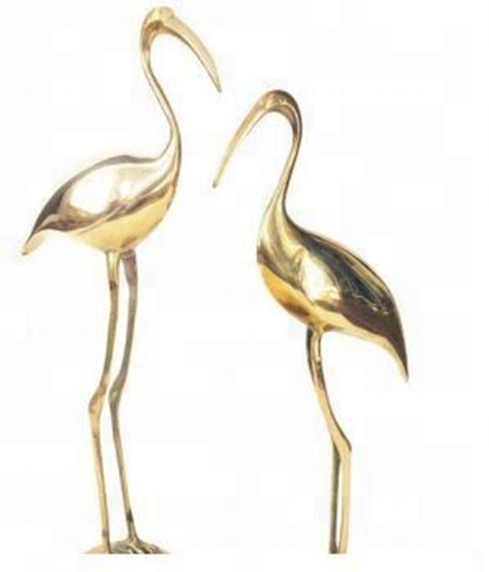 two golden crane sculpture