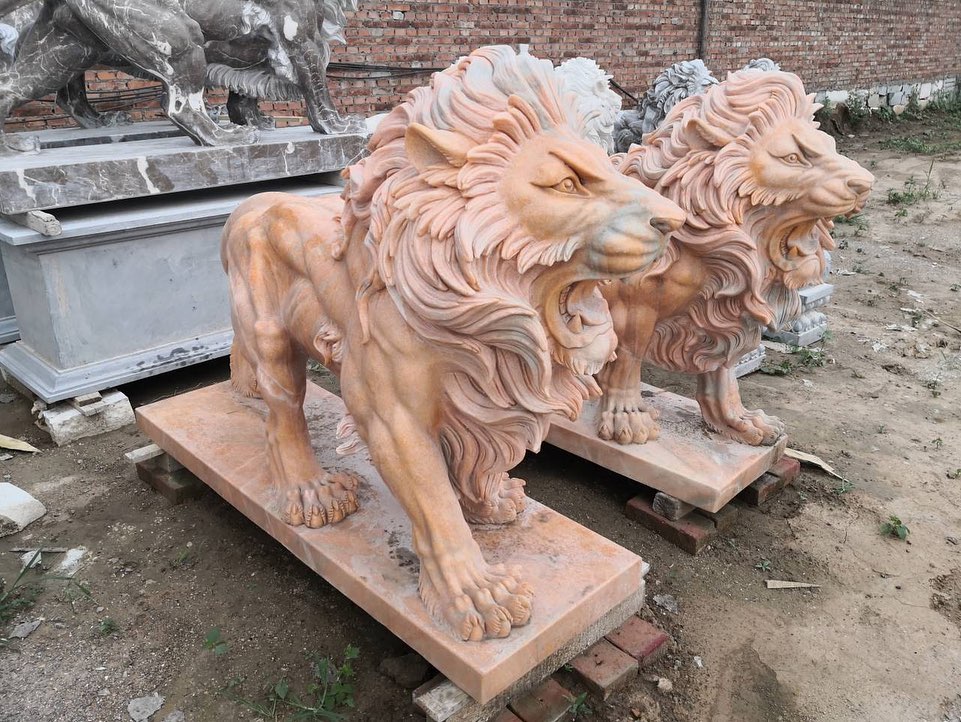 Evening red stone lions statues